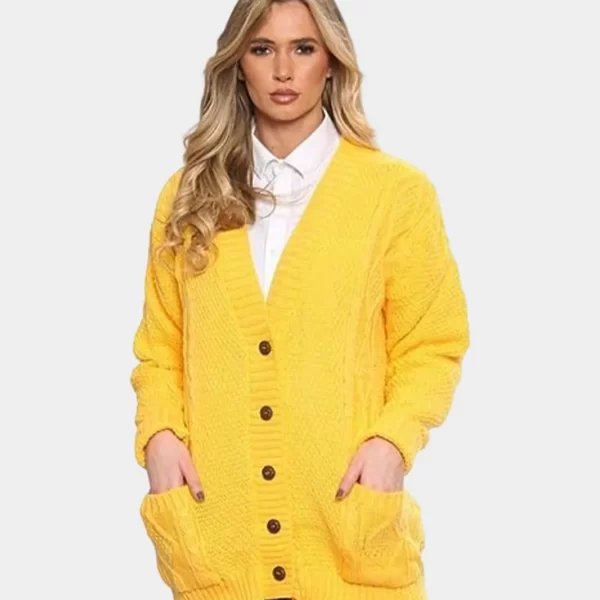 A beautiful blond hair woman wearing chunky cable knitted button cardigan for women in yellow color against solid grey background